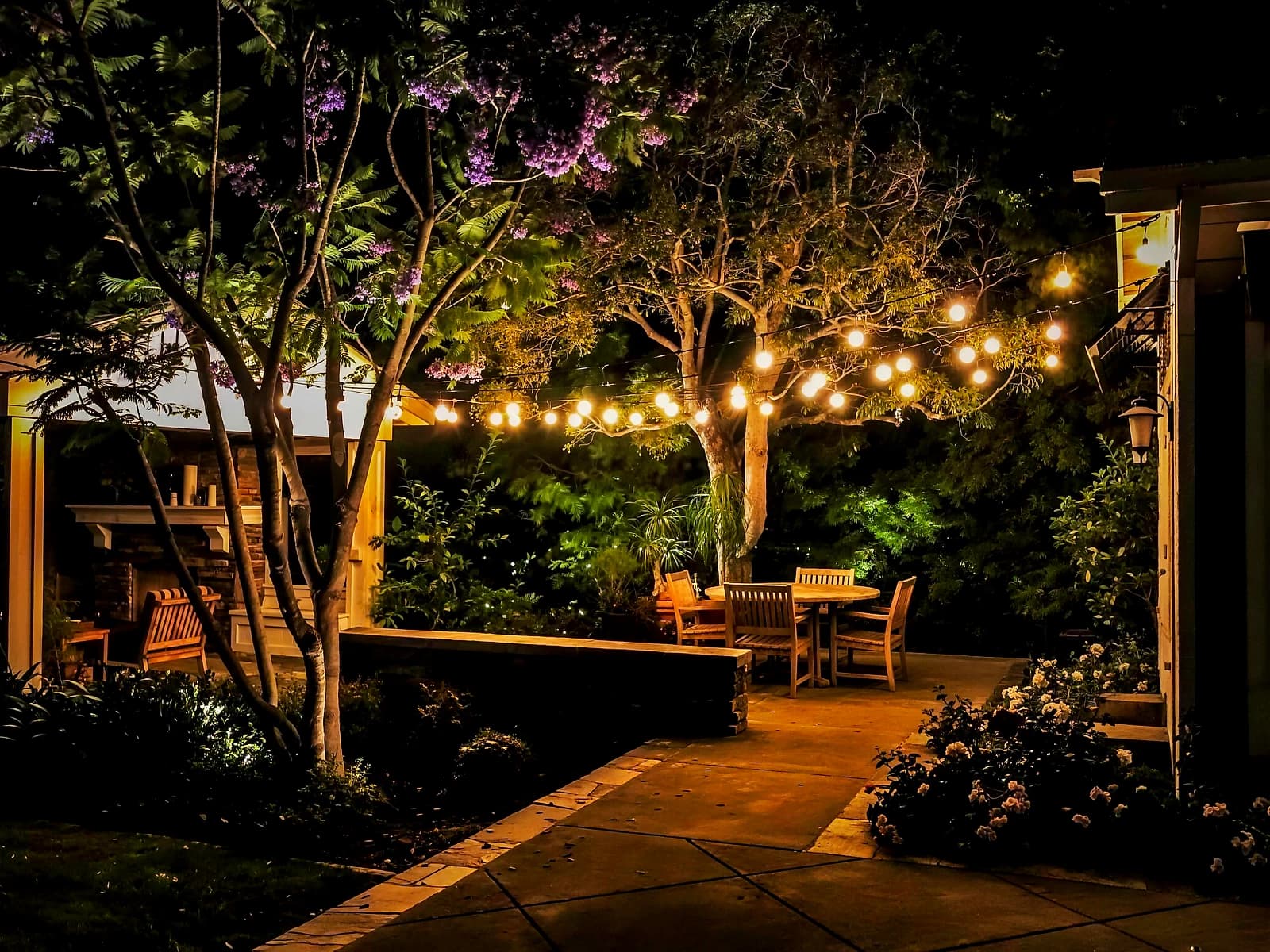 Restaurant courtyard patio strung overhead with warm filament bistro cafe lights